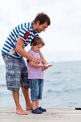 Image showing Father and son caught fish