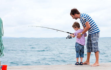 Image showing Father and son fishing together