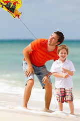 Image showing Father and son flying kite together 