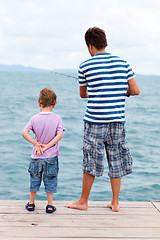 Image showing Father and son fishing from pier
