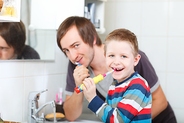 Image showing Father and son brushing teeth