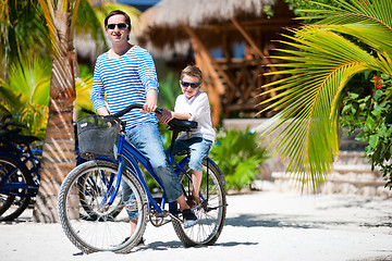 Image showing Father and son on bike