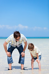 Image showing Father and son at shallow water