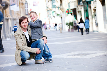 Image showing Father and son outdoors in city