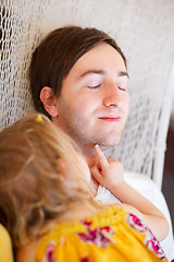 Image showing Father and daughter relaxing in hammock