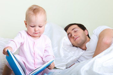 Image showing Baby reading to father