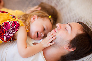 Image showing Father and daughter relaxing in hammock