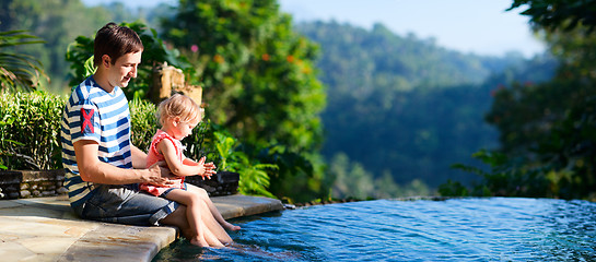 Image showing Father and daughter near swimming pool