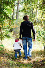 Image showing Father and daughter walking in park