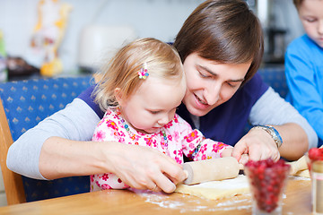 Image showing Father and daughter baking together