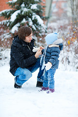 Image showing Father and daughter outdoors at winter