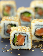 Image showing sushi with salmon and cucumber with sesame seeds