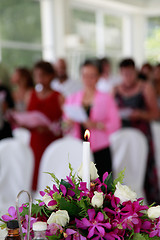 Image showing Candle burning inside a church.