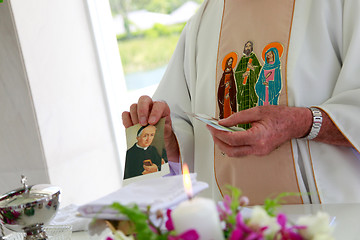 Image showing Candle burning inside a church.