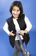 Image showing little girl riding scooter