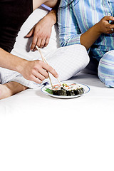 Image showing eating sushie on couch