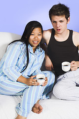 Image showing couple drinking coffee on couch