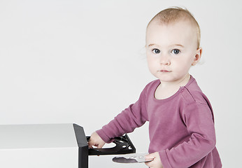 Image showing young child playing with CD