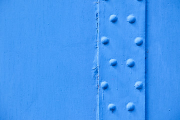 Image showing blue metal surface with rivets