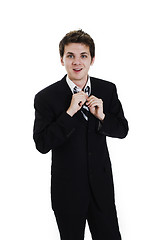 Image showing business man adjusting tie