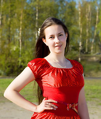 Image showing portrait of a beautiful girl in a red dress with her hair