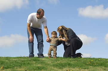 Image showing mon and dad talking to son