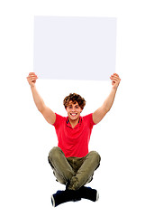 Image showing Trendy guy holding advertising board