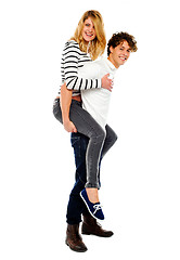 Image showing Boyfriend giving piggy ride to his girl