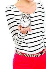 Image showing Cropped image of a woman holding alarm clock