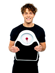 Image showing Attractive athlete showing weighing scale