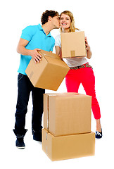 Image showing Young couple gently holding cartons