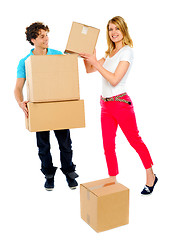 Image showing Smiling couple moving cardboard boxes