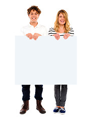 Image showing Young couple standing with white board