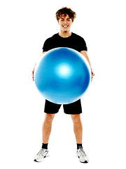 Image showing Male fitness trainer holding a pilate ball