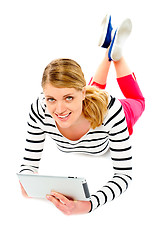 Image showing Young woman holding her tablet computer