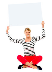 Image showing Woman holding banner ad over her head