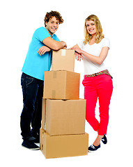 Image showing Teenager couple posing beside cardboard boxes