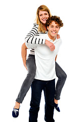 Image showing Boy piggybacks his girlfriend