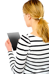 Image showing Rear view of teenage girl using touch screen device