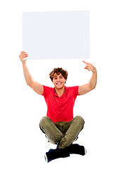 Image showing Cool guy pointing towards white blank billboard