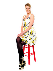 Image showing Glamourous woman sitting on stool