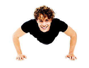 Image showing Healthy young guy doing push-ups