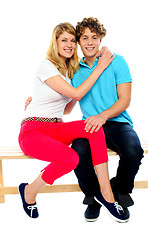 Image showing Young couple hugging on bench