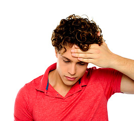 Image showing Stressed out guy with hand on his forehead