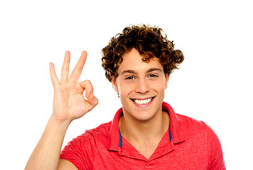 Image showing Curly hair guy gesturing excellence sign