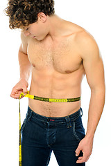 Image showing Muscular man measuring his waist