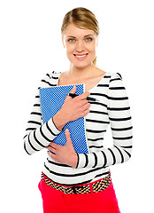 Image showing Smiling lady posing with pen and notepad