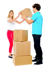 Image showing Couple carrying empty cartons