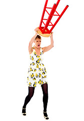 Image showing Frustrated woman breaking stool