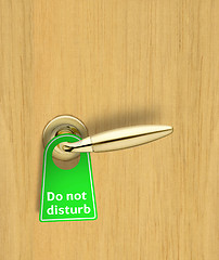 Image showing Hotel wood door with a Do not disturb sign